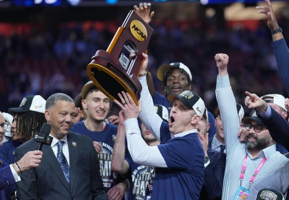 UConn head coach Dan Hurley hoists the NCAA championship trophy after the Huskies defeated the Purdue Boilermakers in the national title game Monday night.
