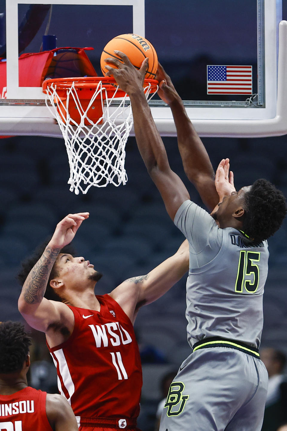 Baylor forward Josh Ojianwuna (15) dunks as Washington State forward DJ Rodman (11) defends during an NCAA college basketball game on Sunday, Dec. 18, 2022, in Dallas. Baylor won 65-59. (AP Photo/Brandon Wade)