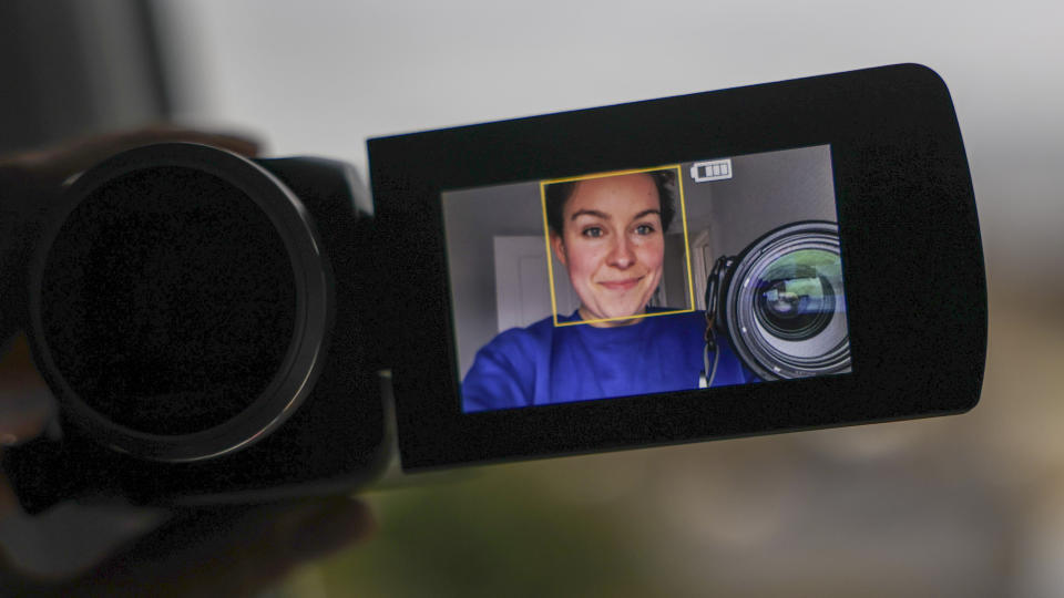 The Panasonic HC-V180 camcorder screen with face-detection on