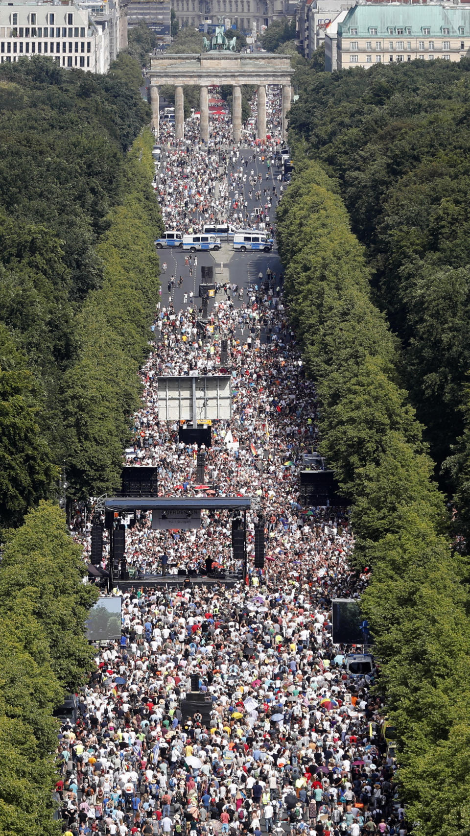 People gather for a demonstration with the slogan ‚The end of the pandemic - freedom day' - against coronavirus restrictions in Berlin, Germany, Saturday, Aug. 1, 2020. It comes amid increasing concern about an upturn in infections in Germany. (AP Photo/Markus Schreiber)