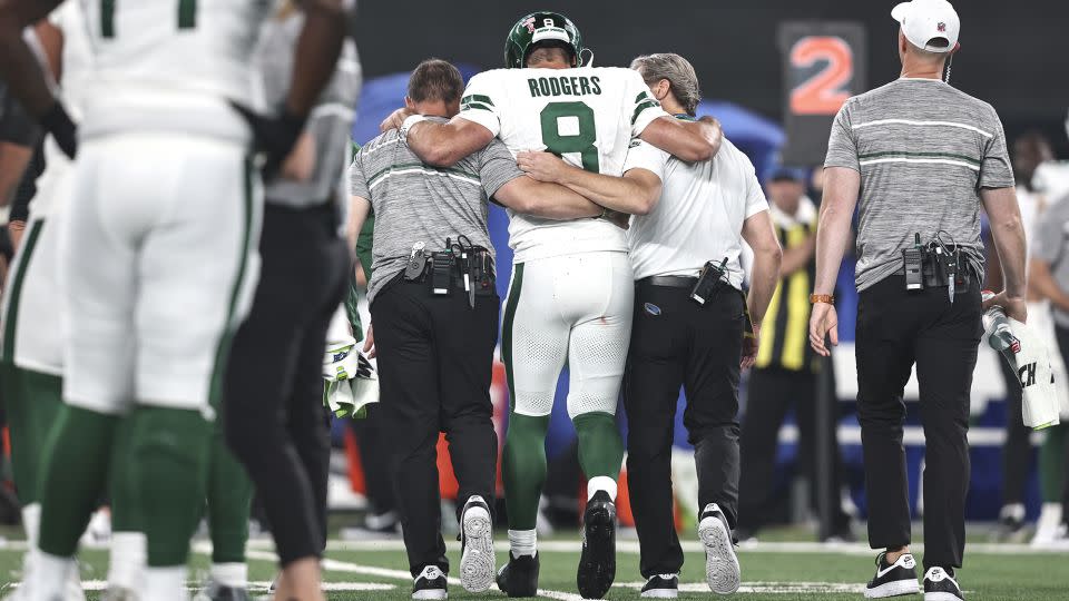 Rodgers is helped off the field after suffering his season-ending injury during the game against the Buffalo Bills. - Michael Owens/Getty Images