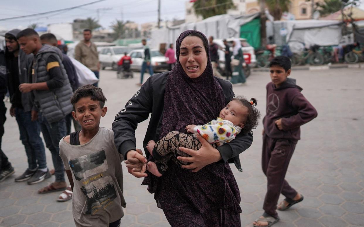 Palestinians outside a hospital where casualties of Israeli bombing on al-Bureij camp in central Gaza were being treated