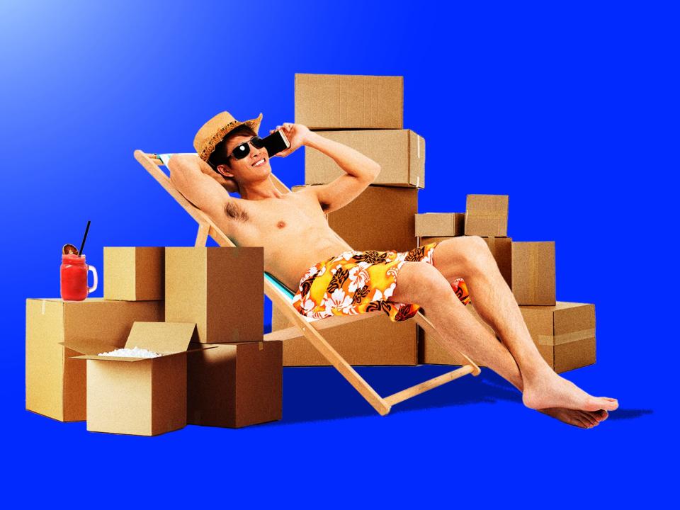 A young man lounging around cardboard boxes