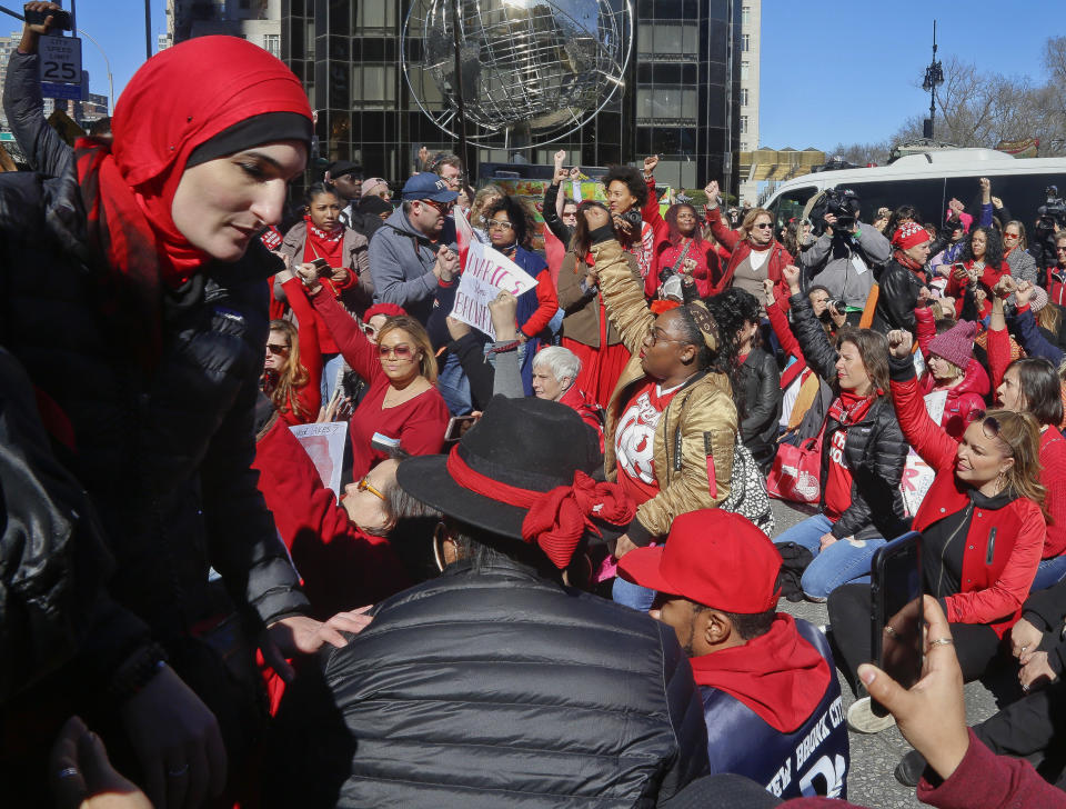 FILE - This March 8, 2017, file photo shows civil rights leader and activist Linda Sarsour, far left, during the International Women's Day rally and sit-down protest outside Trump International Hotel at Columbus Circle, in New York. Conflicts over control, inclusivity and alleged anti-Semitism mean that women protesting on the second anniversary of the Women’s March on Washington will have competing demonstrations Saturday, Jan. 19, 2019, in New York City. (AP Photo/Bebeto Matthews, File)