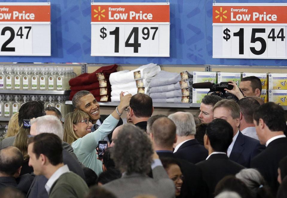 President Barack Obama poses for a selfie photo after speaking at a Walmart store in Mountain View, Calif., Friday, May 9, 2014. Obama announced new steps by companies, local governments and his own administration to deploy solar technology, showcasing steps to combat climate change that don't require consent from a disinclined Congress. (AP Photo/Jeff Chiu)