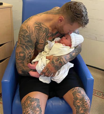 Kyle Christie/Instagram Kyle Christie cuddles with his newborn son Crew Jax following his birth.