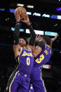 Los Angeles Lakers guard Russell Westbrook, left, grabs a rebound next to teammate Anthony Davis during the first half of an NBA basketball game against the Phoenix Suns, Friday, Oct. 22, 2021, in Los Angeles. (AP Photo/Marcio Jose Sanchez)
