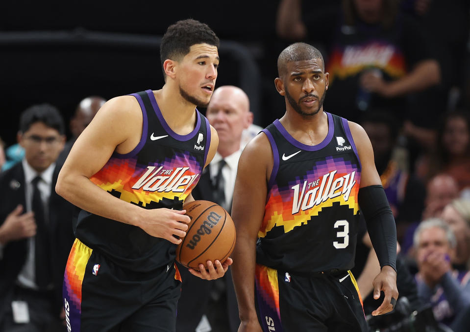 PHOENIX, ARIZONA - MAY 02: Devin Booker #1 and Chris Paul #3 of the Phoenix Suns react after defeating the Dallas Mavericks in Game One of the Western Conference Second Round NBA Playoffs at Footprint Center on May 02, 2022 in Phoenix, Arizona.  The Suns defeated the Mavericks 121-114. NOTE TO USER: User expressly acknowledges and agrees that, by downloading and or using this photograph, User is consenting to the terms and conditions of the Getty Images License Agreement. (Photo by Christian Petersen/Getty Images)