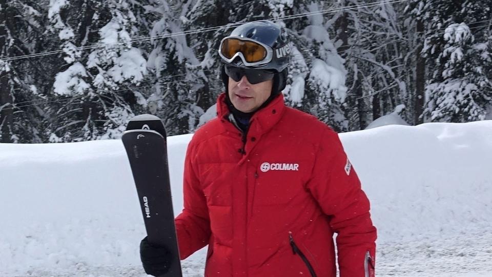 Prince Edward carrying skis in St Moritz