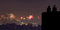 <p>A couple watches fireworks set off by private citizens to celebrate Independence Day from a vantage point at the Liberty Memorial Wednesday, July 4, 2018, in Kansas City, Mo. (Photo: Charlie Riedel/AP) </p>