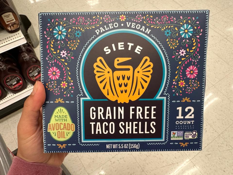 hand holding up a box of siete grain free taco shells at target