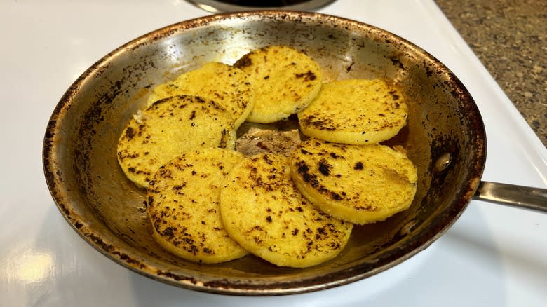 fried polenta rounds in a skillet