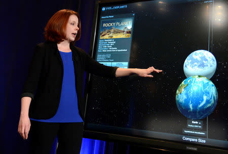 Space Telescope Science Institute astronomer Nikole Lewis uses a graphic to compare the size of Earth (bottom) with a recent discovery of an exoplanet, during a news conference to present new findings on exoplanets, planets that orbit stars other than Earth's sun, in Washington, U.S., February 22, 2017. REUTERS/Mike Theiler