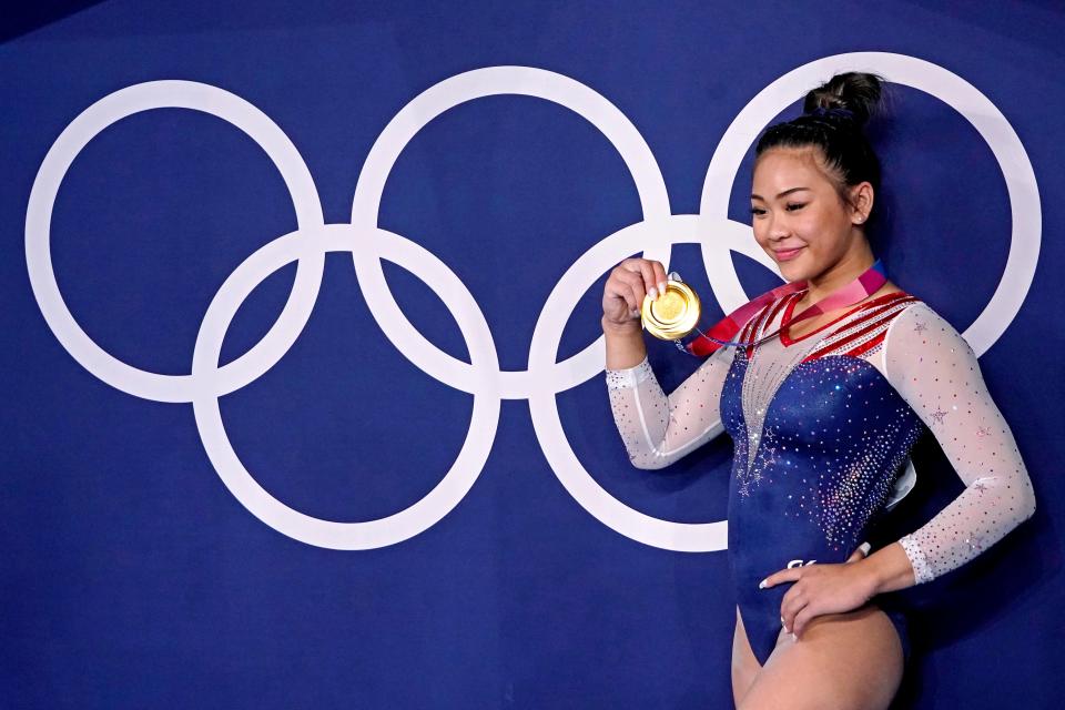 Suni Lee shows off her gold medal from the women's all-around on Thursday.