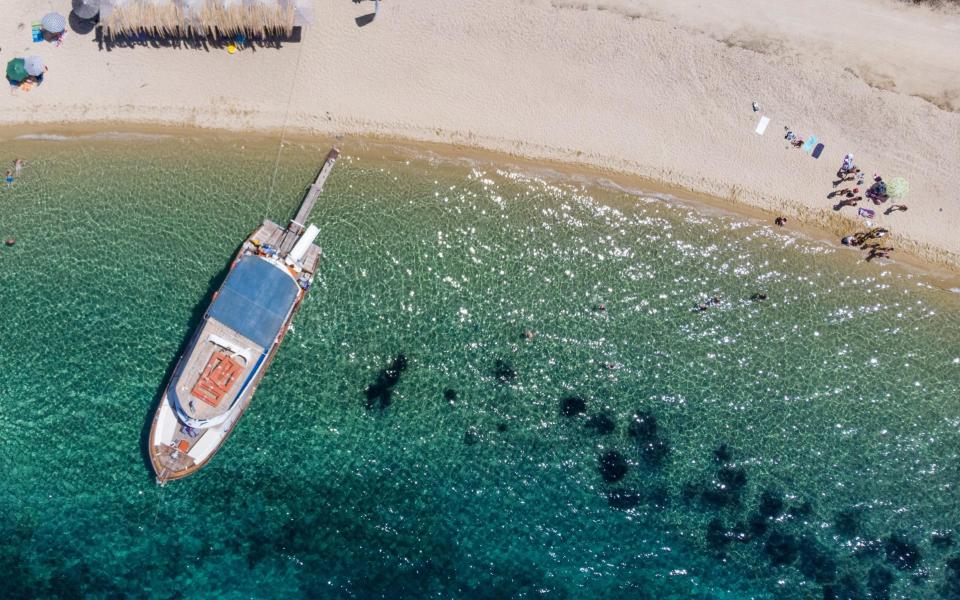 Crowds have been absent from Greek beaches so far this year - Getty