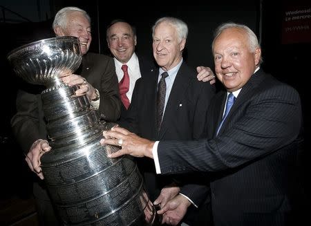 Former hockey greats Jean Beliveau (L), Frank Mahovlich (2nd L), Gordie Howe (2nd R) and Yvan Cournoyer (R) pose with the Stanley Cup at a tribute for Beliveau in Montreal, Quebec, Canada on April 30, 2008. REUTERS/Christinne Muschi/File Photo