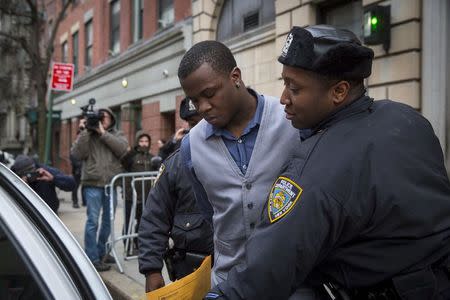 Shezoy Bleary, who was taken into custody over the stabbing of NBA player Chris Copeland of the Indiana Pacers and his wife, is escorted out of the 10th Precinct of the New York Police Department in Manhattan, New York April 8, 2015. REUTERS/Andrew Kelly