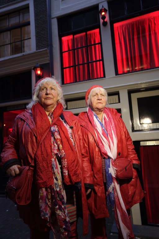 Decked out in matching red leather jackets and boots, red jeans and crocheted red berets, with Stars and Stripes scarves draped around their necks, the Fokkens cut a jaunty pair as they saunter down alleys with red-framed windows where semi-nude 'working women' put their bodies on display to lure customers