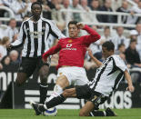 NEWCASTLE, ENGLAND - AUGUST 28: Cristiano Ronaldo of Manchester United clashes with Shola Ameobi and Jermaine Jenas of Newcastle United during the Barclays Premiership match between Newcastle United and Manchester United at St James' Park on August 28, 2005 in Newcastle, England. (Photo by John Peters/Manchester United via Getty Images)
