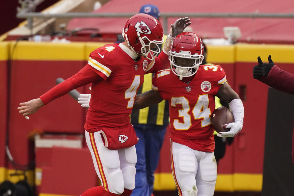 Kansas City Chiefs running back Darwin Thompson (34) celebrates with quarterback Chad Henne (4) after scoring on a 1-yard touchdown run during the first half of an NFL football game against the Los Angeles Chargers, Sunday, Jan. 3, 2021, in Kansas City. (AP Photo/Charlie Riedel)