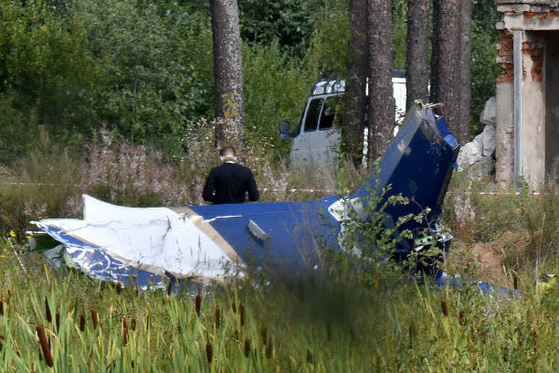 A law enforcement officer works at the site of a plane crash near the village of Kuzhenkino, Tver region, on  24 August 2023 (AFP via Getty Images)