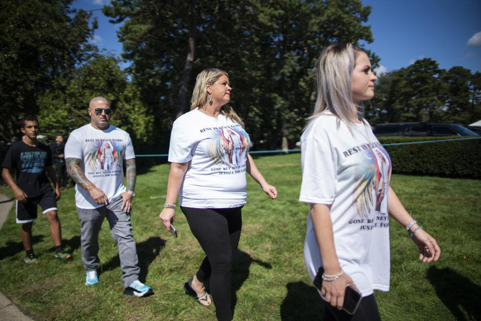 CORRECTS TO FUNERAL HOME VIEWING INSTEAD OF FUNERAL People wear T-shirts with images of Petito as they attend the funeral home viewing of Gabby Petito at Moloney's Funeral Home in Holbrook, N.Y. Sunday, Sept. 26, 2021. (AP Photo/Eduardo Munoz Alvarez)