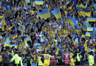 Ukraine's Roman Yaremchuk celebrates with fans after scoring his side's second goal during the World Cup 2022 qualifying play-off soccer match between Scotland and Ukraine at Hampden Park stadium in Glasgow, Scotland, Wednesday, June 1, 2022. (AP Photo/Scott Heppell)