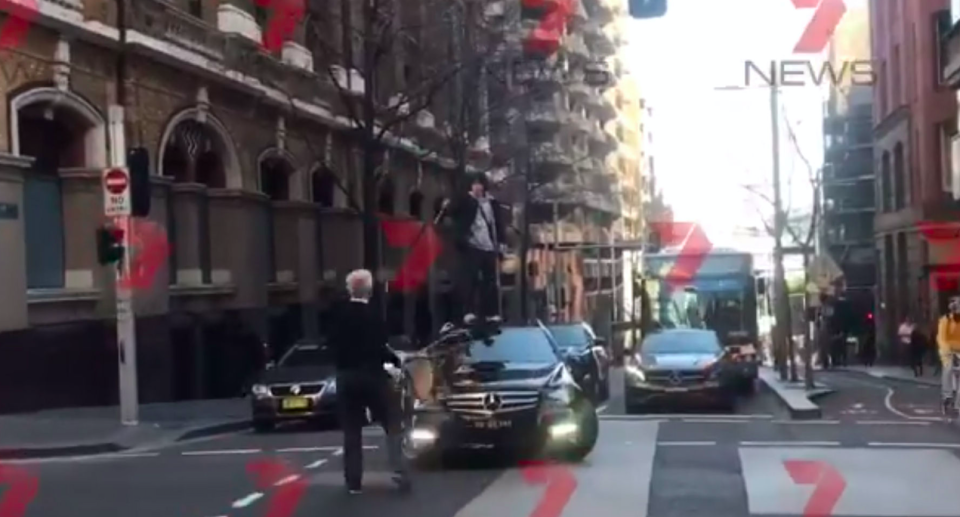 Screengrab of a man wielding a knife as he is approached by a member of the public with a chair (Andrew Denney/7 News/PA)