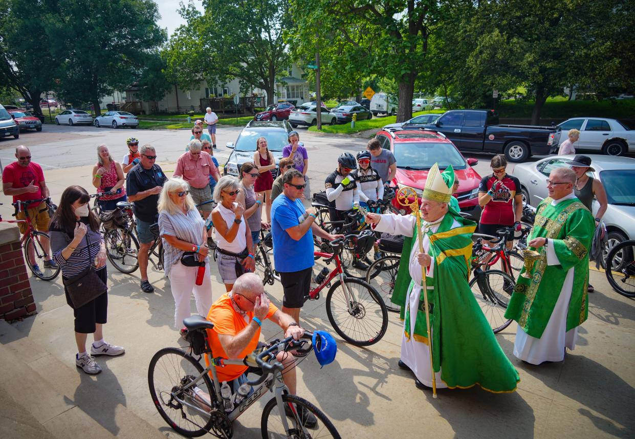 Bishop R. Walker Nickless blesses cyclists outside of St Boniface Catholic Church in Sioux City on Saturday.