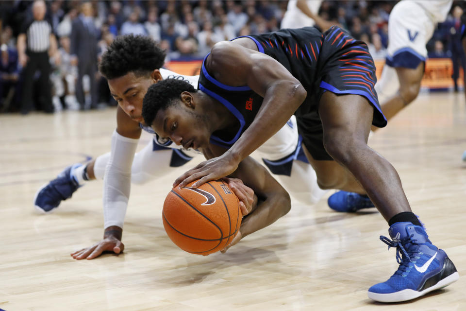 DePaul's Jalen Coleman-Lands, right, and Villanova's Justin Moore battle for a loose ball during the first half of an NCAA college basketball game, Tuesday, Jan. 14, 2020, in Villanova, Pa. (AP Photo/Matt Slocum)