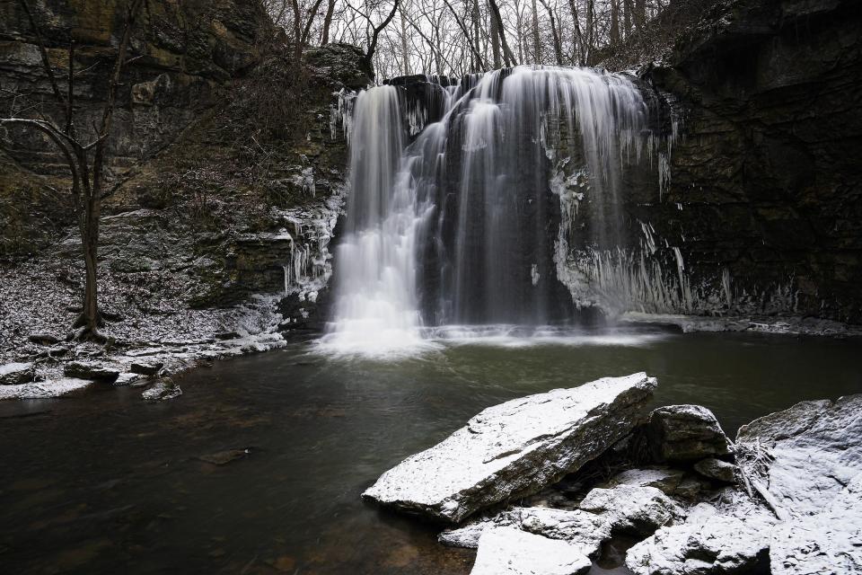 Water falls from a 35-foot waterfall as snow falls for the first time in 2022 at Hayden Falls Park in Columbus on Jan. 6, 2022. Hayden Falls Park located within Griggs Nature Preserve, is on the west side of the Scioto River, just along Hayden Run Road, west of Griggs Reservoir bridge.