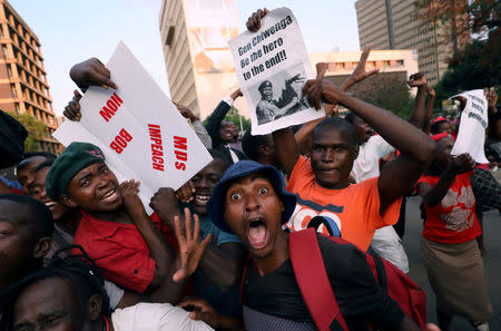 FILE PHOTO: Zimbabweans celebrate after President Robert Mugabe resigns in Harare, Zimbabwe November 21, 2017. REUTERS/Mike Hutchings/File Photo