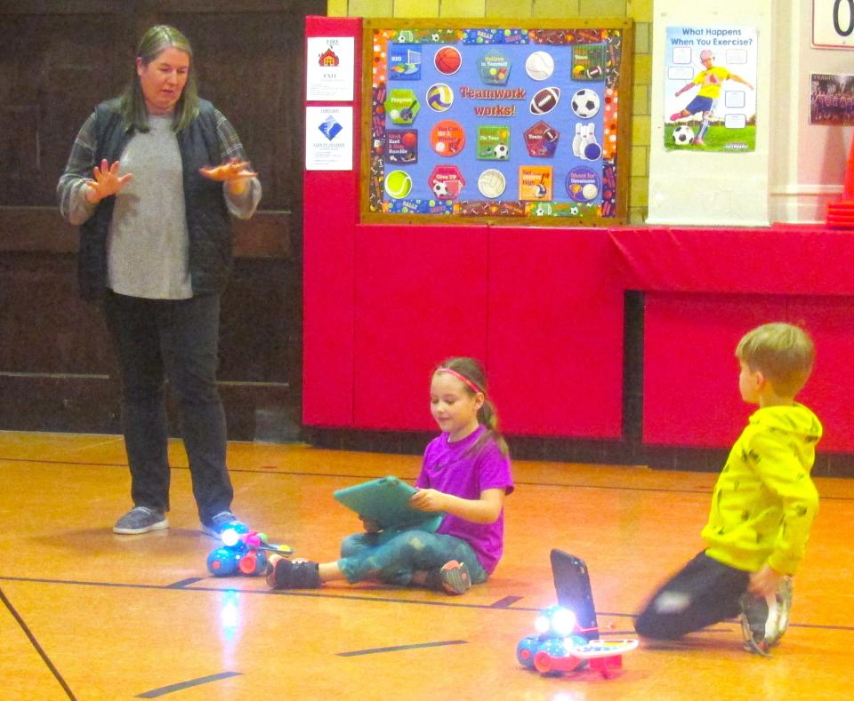 Nashville Elementary second-grade teacher Brooke Mast explains the robotics projects her students, Adilee Kurtz (middle) and Huxley Angle, were about to demonstrate for the school board at Monday's West Holmes Local Board of Education meeting.