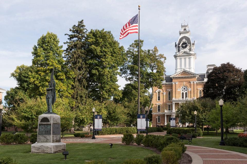 Hillsdale College's Central Hall is pictured behind the backdrop of the campus' Civil War Memorial.