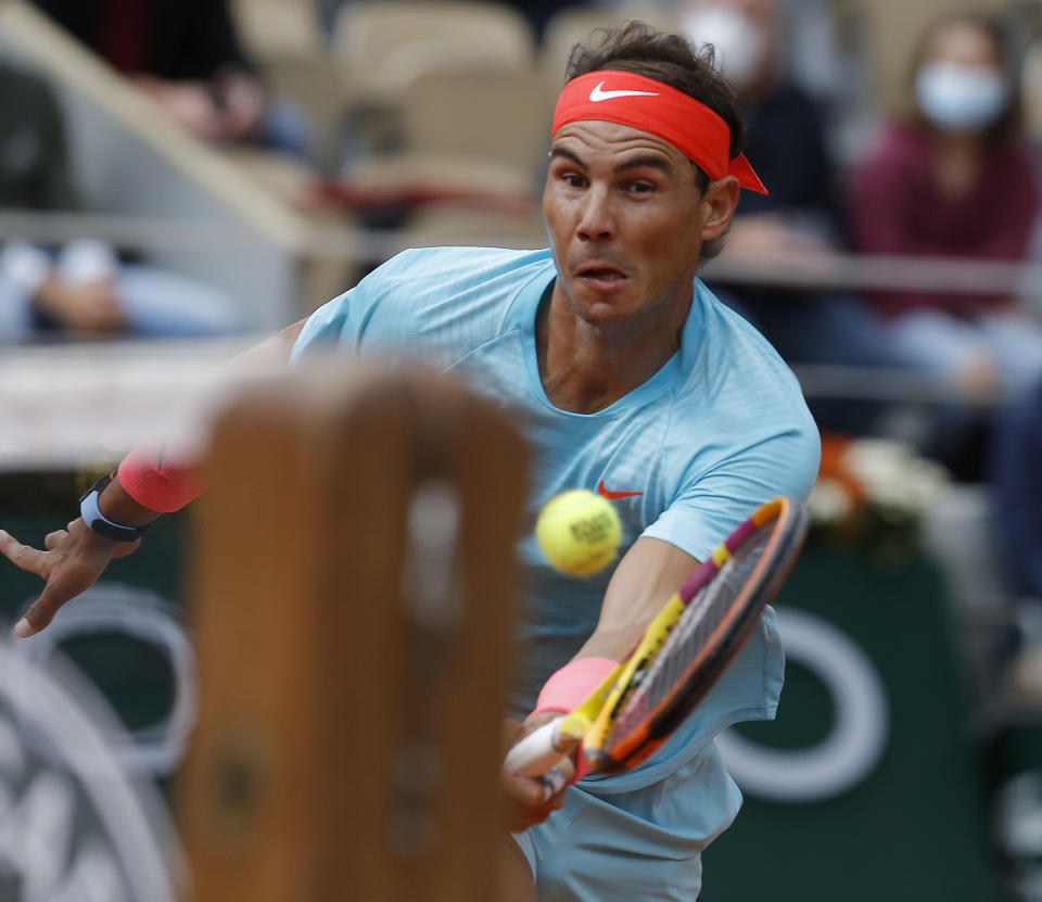 Spain's Rafael Nadal runs to the net to play a shot against Argentina's Diego Schwartzman in the semifinal match of the French Open tennis tournament at the Roland Garros stadium in Paris, France, Friday, Oct. 9, 2020. (AP Photo/Michel Euler)