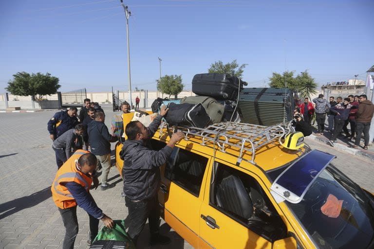 Los palestinos varados en Egipto llegan a la Franja de Gaza por el cruce de Rafah cuando entró en vigor un alto el fuego temporal 