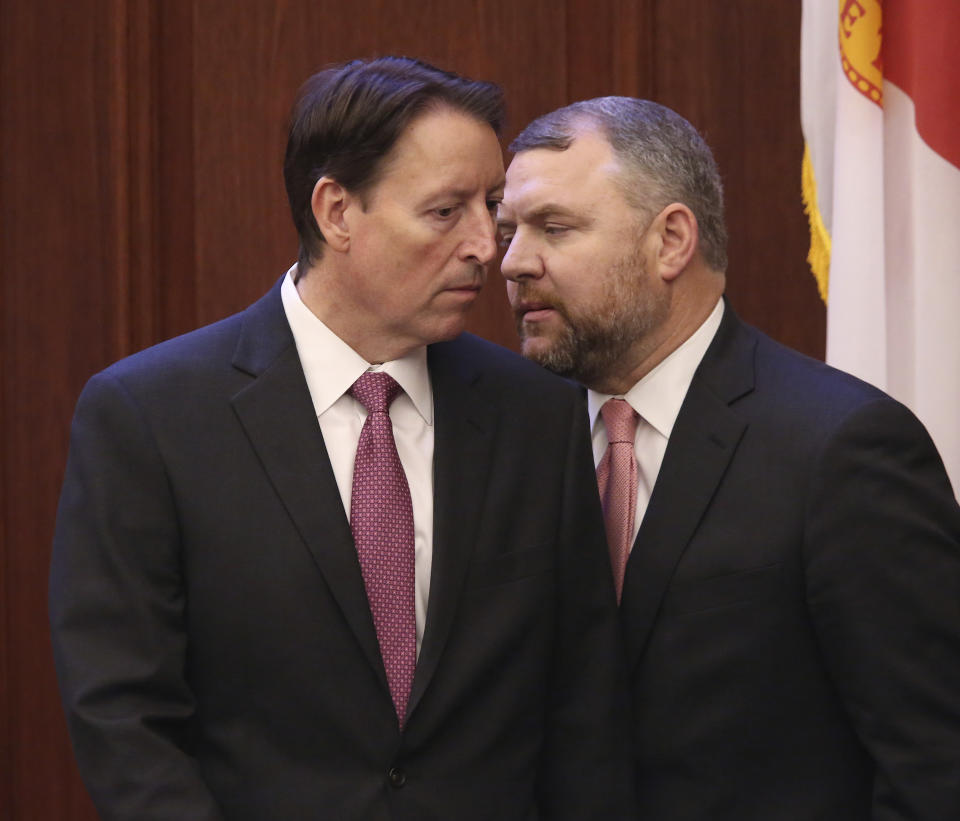 State Sen. Rob Bradley, R-Fleming Island, right, confers with Senate President Bill Galvano, R-Bradenton, during debate on a bill to allow teachers to be armed during a legislative session Wednesday April 17, 2019, in Tallahassee, Fla. (AP Photo/Steve Cannon)