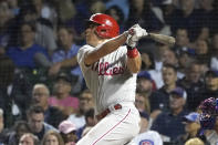 Philadelphia Phillies' J.T. Realmuto watches his single off Chicago Cubs starting pitcher Alec Mills during the sixth inning of a baseball game Wednesday, July 7, 2021, in Chicago. (AP Photo/Charles Rex Arbogast)