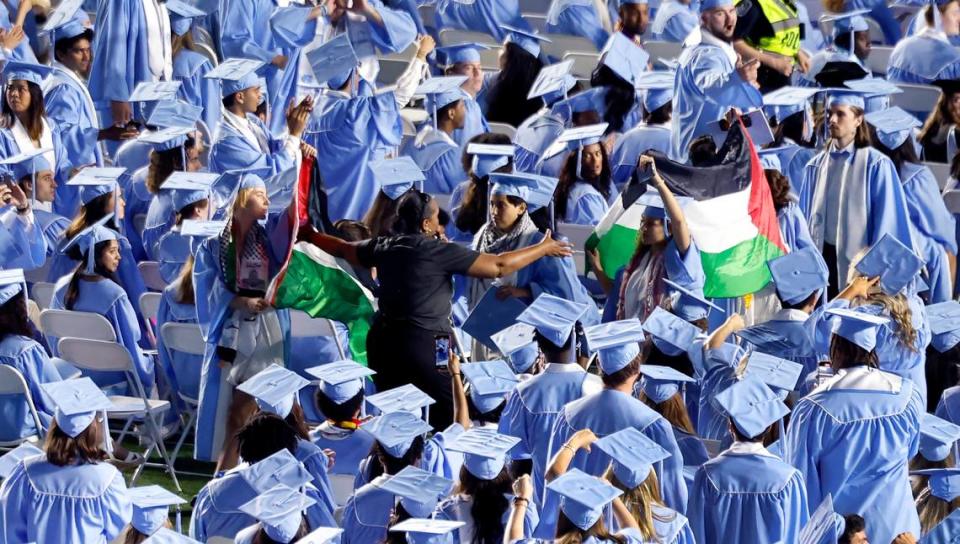 Palestinian flags are taken from protesters as they walk out of UNC Chapel Hill’s commencement ceremonies at Kenan Stadium in Chapel Hill, N.C., Saturday, May 11, 2024. Ethan Hyman/ehyman@newsobserver.com