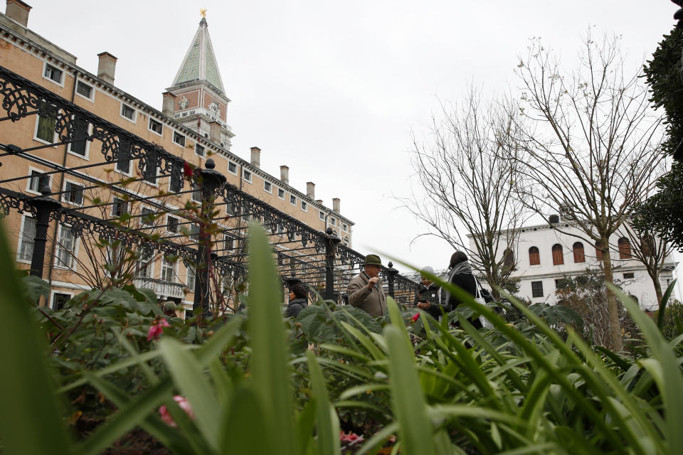 People visit the newly restored Royal Gardens in Venice, Italy, Tuesday, Dec. 17, 2019. Venice’s Royal Gardens were first envisioned by Napolean, flourished under Austrian Empress Sisi and were finally opened to the public by the Court of Savoy, until falling into disrepair in recent years. After an extensive restoration, the gardens reopened Tuesday as a symbol both of the lagoon city’s endurance and the necessity of public-private partnerships to care for Italy’s extensive cultural heritage. (AP Photo/Antonio Calanni)