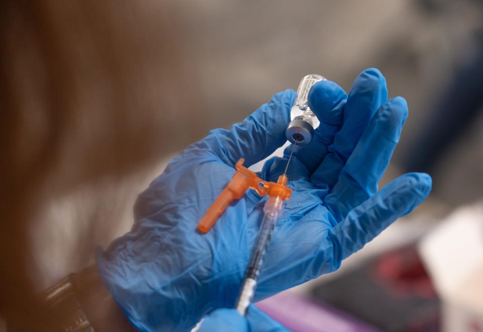 Benzie-Leelanau District Health Department registered nurse Dawn Hynds draws a dose of the Johnson & Johnson Covid-19 vaccine during a community vaccination event at Northport Public School in Northport on Thursday, September 16, 2021.