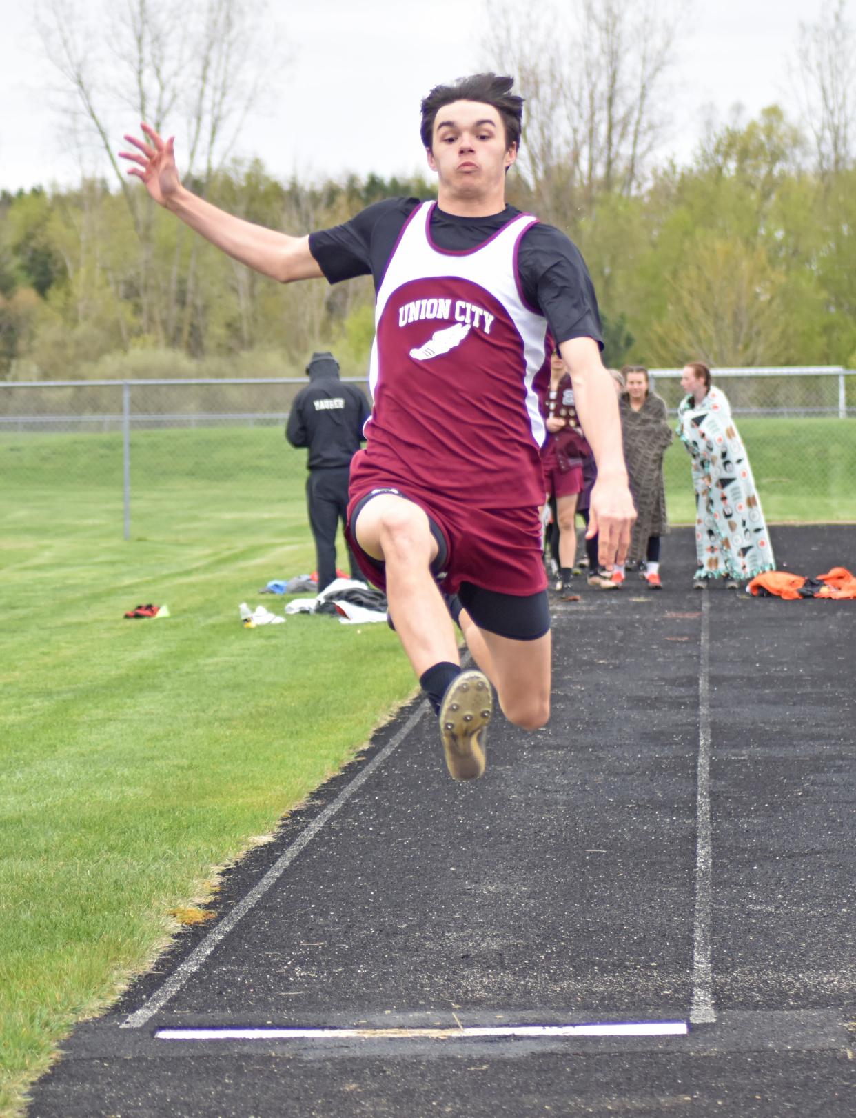 Union City junior Rick Austin flies high on his way to first place in the long jump on Wednesday