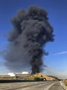 Interstate 80 is closed as a fire at an oil storage facility burns Tuesday, Oct. 15, 2019, in Rodeo, Calif. A fire burning at NuStar Energy LP facility in Crockett, Calif., in the San Francisco Bay Area prompted a hazardous materials emergency that led authorities to order the residents of two communities, including Rodeo, to stay inside with all windows and doors closed. Contra Costa Fire Department spokesman Steve Hill said that an hour into battling the blaze, firefighters seemed to be making progress and were continuing to keep adjacent tanks cooled with water. (AP Photo/Ben Margot)