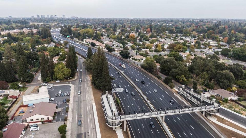 A new pedestrian bridge, photographed by drone on Oct. 31, 2022, near the Little Pocket neighborhood in Sacramento is part the recently completed Interstate 5 enhancement project. After three years of roadwork, the route has a new carpool lane and a fresh road surface, along with other enhancements. Carpool users could save 13 minutes on their commutes.