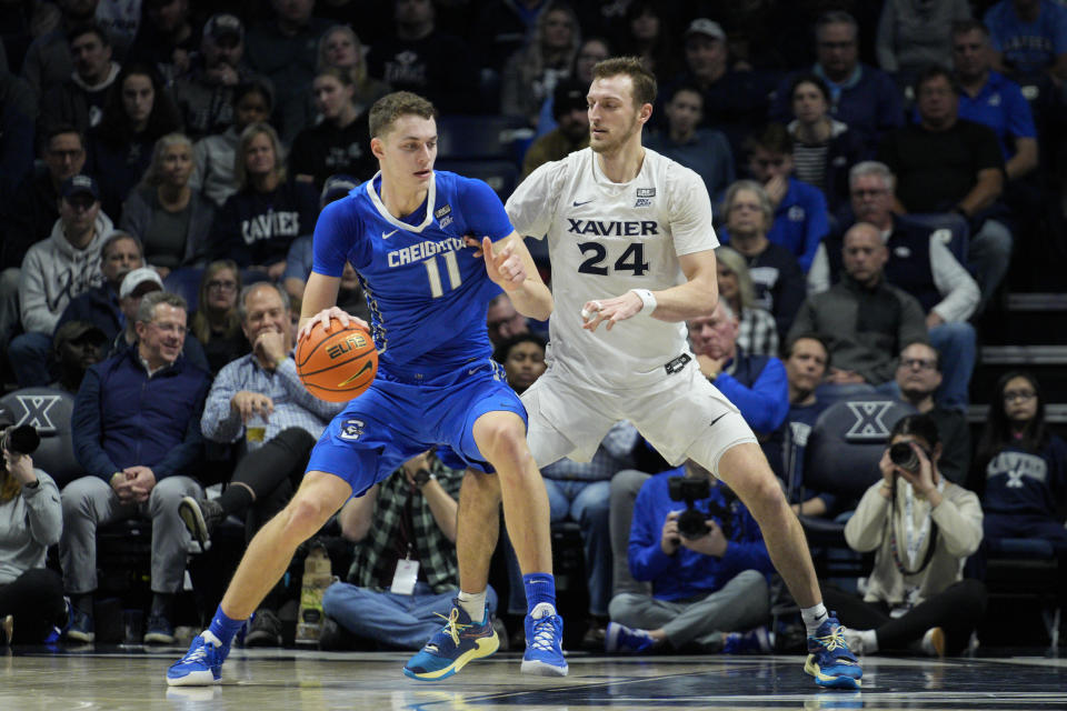 Creighton center Ryan Kalkbrenner (11) is guarded by Xavier's Jack Nunge (24) during the first half of an NCAA college basketball game, Wednesday, Jan. 11, 2023, in Cincinnati. (AP Photo/Jeff Dean)