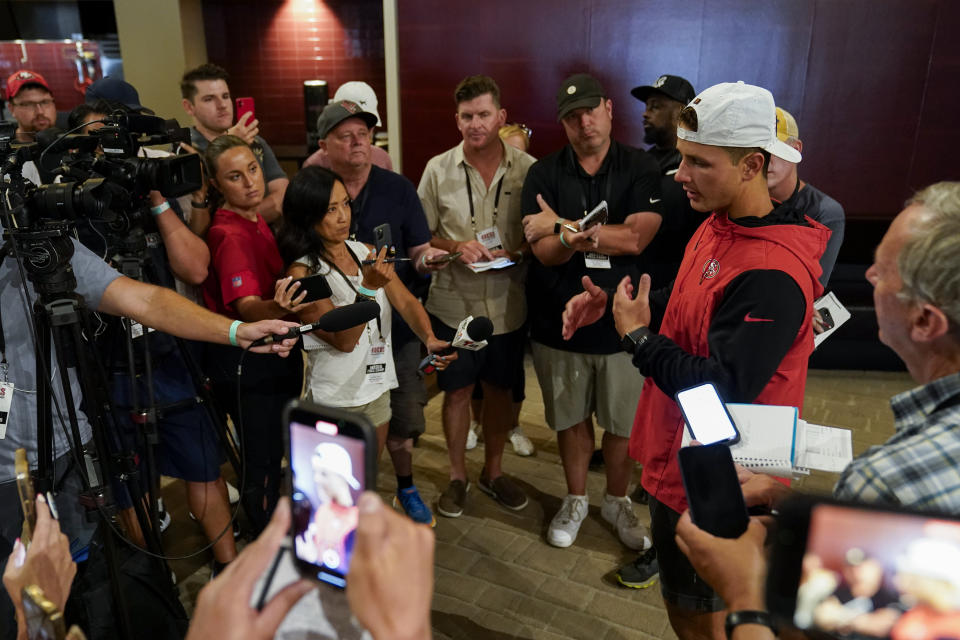 San Francisco 49ers' Brock Purdy, second from right, speaks to reporters after NFL football training camp Friday, Aug. 4, 2023, in Santa Clara, Calif. (AP Photo/Godofredo A. Vásquez)