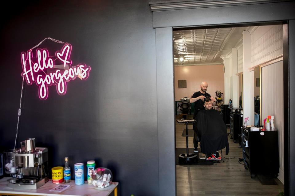 Independent Hair Stylist Gregory Routt styles the hair of Bryan Davis, of Chillicothe, at Salon Niche on April 13, 2023, in Chillicothe, Ohio. Routt is registering his business with an organization called "Strands fo Trans" which allows those who identify as LGBTQIA+, and allies, look online for safe places where they can come feel welcomed within the community. Gregory said he just wants to provide a place where people can feel their most authentic selves.