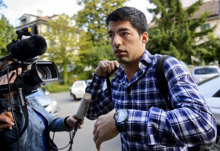 Luis Suarez, currently serving a four-month ban for biting Italy's Giorgio Chiellini at the World Cup, arrives for his appeal before the Court of Arbitration for Sport in Lausanne on August 8, 2014