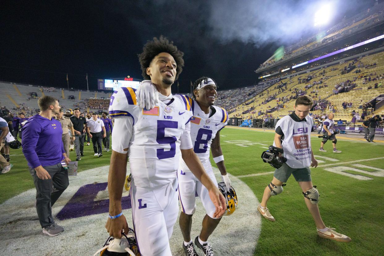 Oct 21, 2023; Baton Rouge, Louisiana, USA; LSU Tigers quarterback Jayden Daniels (5) and wide receiver Malik Nabers (8) walk off the field after defeating the Army Black Knights at Tiger Stadium. Mandatory Credit: Matthew Hinton-USA TODAY Sports
