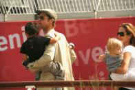 <p>Brad Pitt carries one of his children with Angelina Jolie as they head to the Venice airport in September 2007. </p>